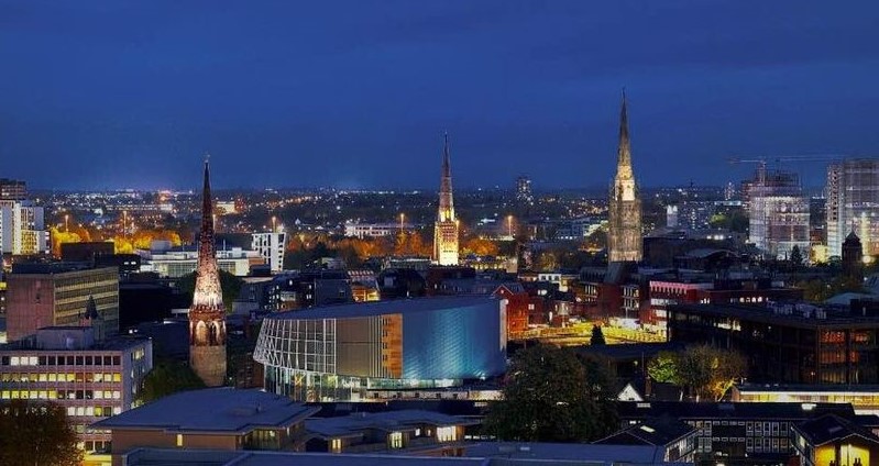 A photograph of the city skyline with three spires at night